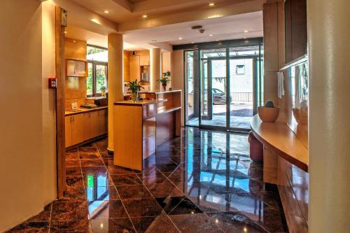 a large kitchen with a counter and a hallway at Hotel Skradinski Buk in Skradin