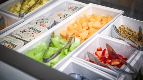 an open refrigerator filled with fruits and vegetables at Holiday Inn Nashville Airport by IHG in Nashville
