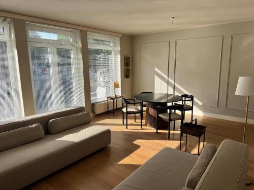 a living room with a couch and a table at Spacious apartment with roof terrace and balcony in Arnhem