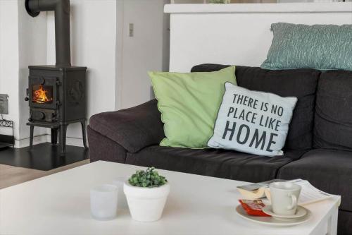 a couch with a pillow that says there is no place like home at HS008-Henne-Porsevej-10 in Henne Strand