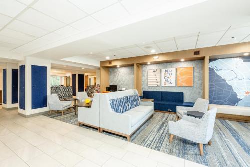 a lobby of a hospital with chairs and a couch at Holiday Inn Express Hotel & Suites Charleston-Ashley Phosphate by IHG in Charleston