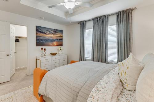 a white bedroom with a bed and a window at Modern Comforts and Fenced Yard Princeton Retreat! in Princeton