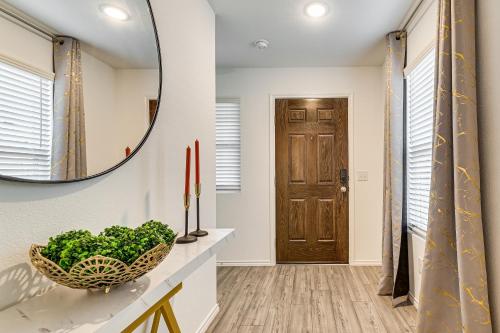 a hallway with a mirror and a bowl of greens at Modern Comforts and Fenced Yard Princeton Retreat! in Princeton