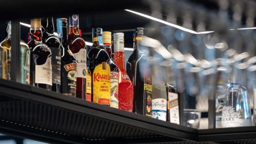a shelf filled with lots of bottles of wine at Holiday Inn Express & Suites Lisbon - Príncipe Real by IHG in Lisbon