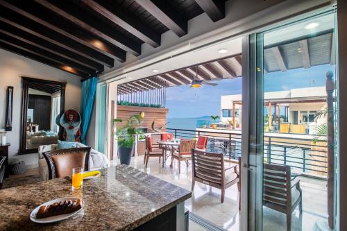 an open kitchen and dining room with a view of the ocean at Pinnacle Resorts 180 in Puerto Vallarta