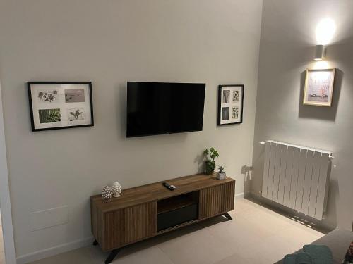 a living room with a flat screen tv on a wall at Dimore del Borgo in Catania