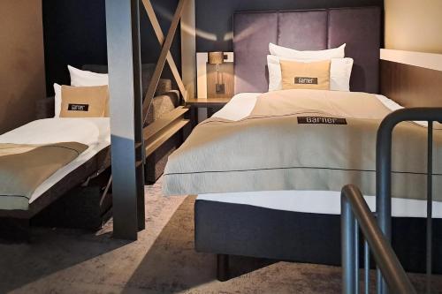 two beds in a room with two beds sidx sidx sidx at Garner Hotel Elmshorn by IHG in Elmshorn