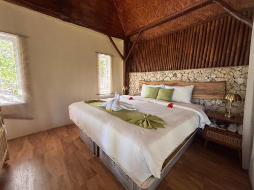 a bedroom with a large bed in a room at Gading Tree House in Nusa Penida