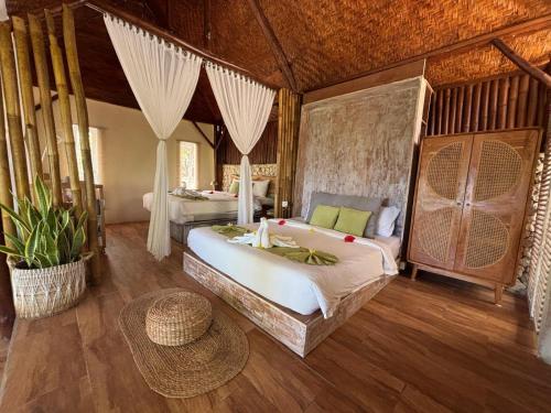 a bedroom with a large bed in a room at Gading Tree House in Nusa Penida