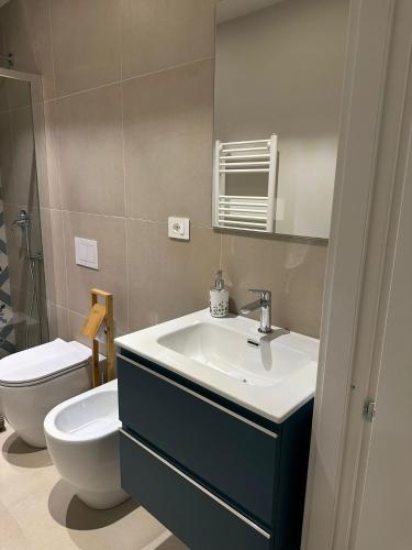 a bathroom with a sink and a toilet at Dimore del Borgo in Catania