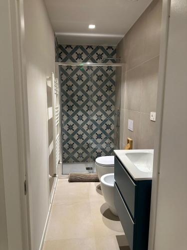 a bathroom with a toilet and a sink at Dimore del Borgo in Catania