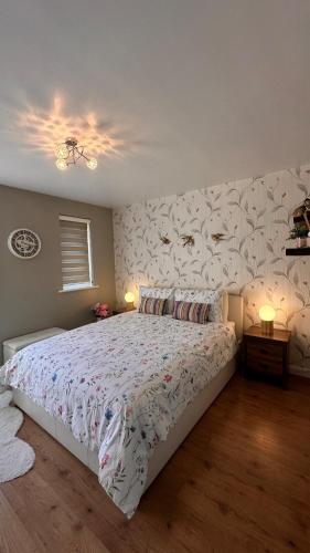 a bedroom with a bed and a wall with fishes on it at Cozy Apartment in London