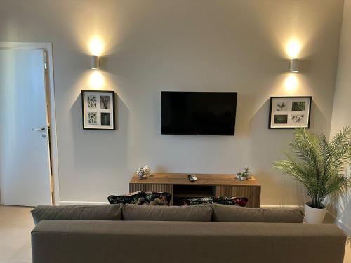 a living room with a couch and a flat screen tv at Dimore del Borgo in Catania