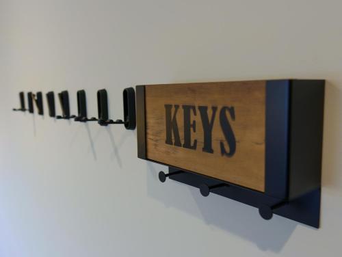 a row of keys signs on a wall at Luxehaus MCR in Manchester