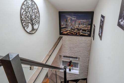 a staircase with a large clock on the wall at Luxehaus MCR in Manchester