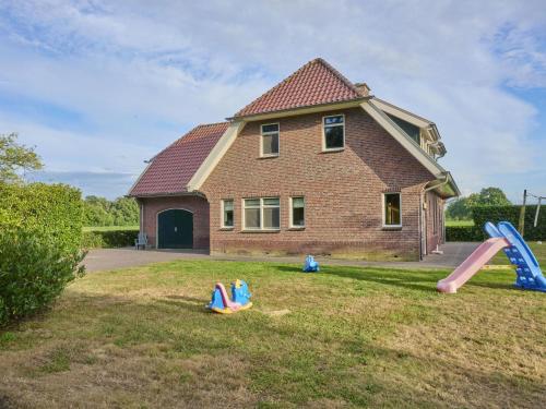 a house with playground equipment in the yard at t Achterhoes in Diepenheim