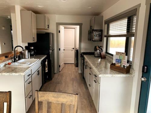 a kitchen with white cabinets and a counter top at Mulberry House in Fruita