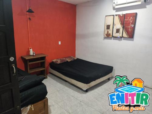 a bedroom with two beds and a table in it at Bungalows Cabaña Rivera in Campeche