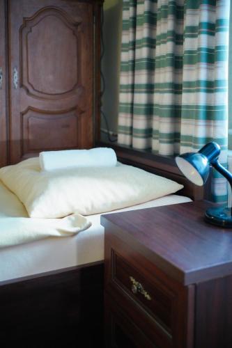 a bedroom with two beds and a desk with a lamp at POKOJE GOŚCINNE IRGA in Starogard Gdański