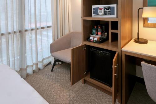 a hotel room with a bed and a chair at Holiday Inn Hotel & Suites Mexico Medica Sur by IHG in Mexico City