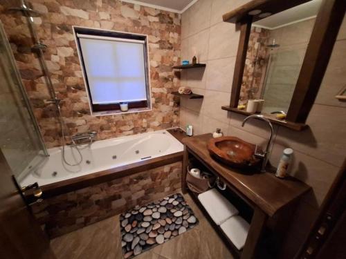 a bathroom with a bath tub and a sink at Apartments with parking space Trsce, Gorski kotar - 24880 in Tršće