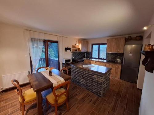 a kitchen with a table and a dining room at Apartments with parking space Trsce, Gorski kotar - 24880 in Tršće