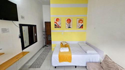 a small room with a bed and a tv at Suite 1 - Centro de Convenções700m, AC, WIFI in Recife