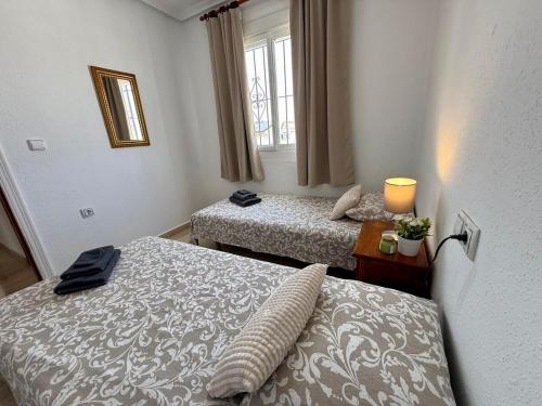 a hotel room with two beds and a window at Camposol Villa Mazarron, Spain in Mazarrón