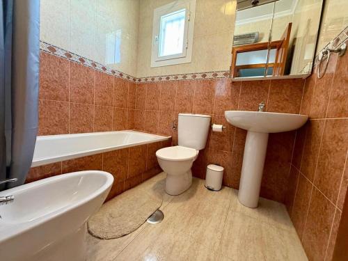 a bathroom with a toilet and a sink and a tub at Camposol Villa Mazarron, Spain in Mazarrón