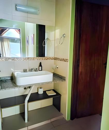 a bathroom with a sink and a mirror at Mi Casa Tu Casa B , Departamento centrico in Lago Puelo