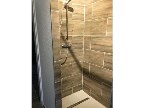 a bathroom with a shower with wooden tiles at Holiday apartment in Nahrendorf with barbecue in Nahrendorf