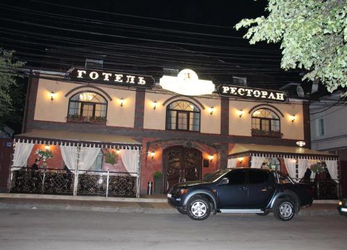 a black car parked in front of a hotel at Aristokrat in Vinnytsya