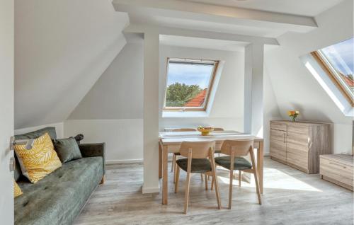 a living room with a table and a couch at 3 Bedroom Awesome Apartment In Altenkirchen in Altenkirchen