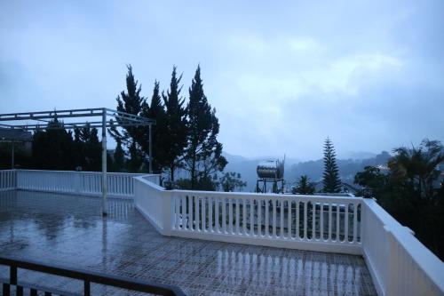 a balcony with a white fence and a view at Famille Hotel - Central hotel in Dalat in Xuan An