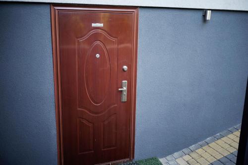 a brown wooden door on a building at Lawendowe Studio in Starogard Gdański