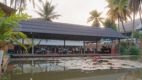 a pavilion with a pond with lily pads in the water at Villa Oasis in Luang Prabang