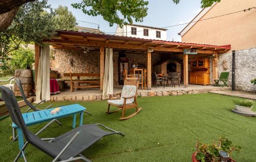 a patio with a table and chairs in a yard at Gorgeous Apartment In Karlobag With Wifi in Karlobag