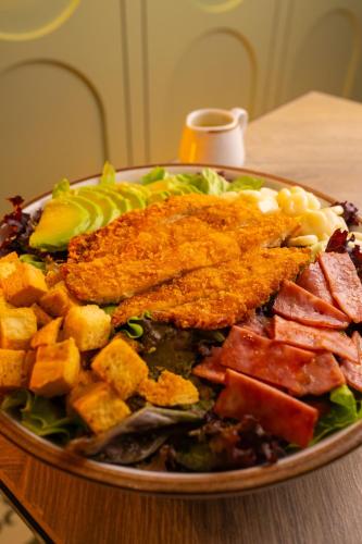 a plate of food with meat and vegetables on a table at Posada Blanca Hotel Boutique in Piura