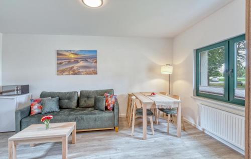 a living room with a couch and a table at Nice Apartment In Altenkirchen in Altenkirchen