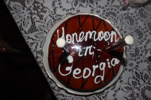 a piece of chocolate cake with writing on it at Giorgi's Homestay in Kutaisi
