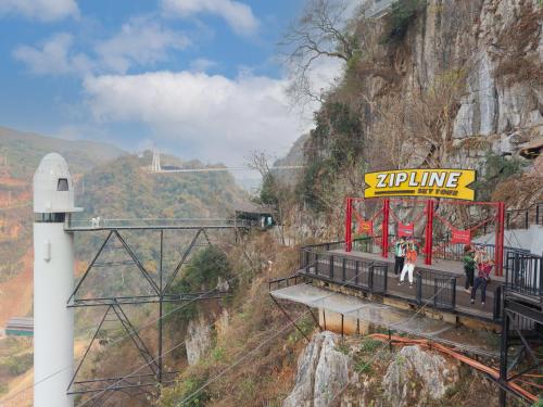 a train station on a mountain with people on it at Moc Chau Island - Bach Long Glass Bridge in Mộc Châu