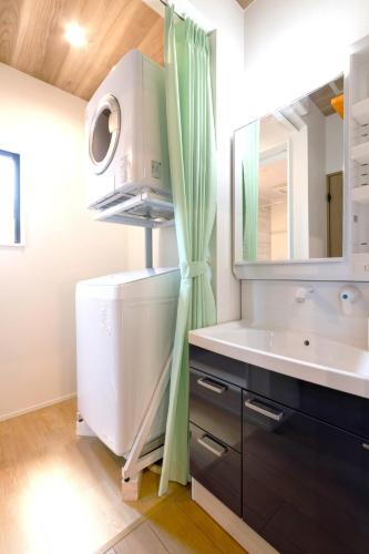 a bathroom with a sink and a large mirror at Trailer Ship Garden Aso - Vacation STAY 96758v in Aso
