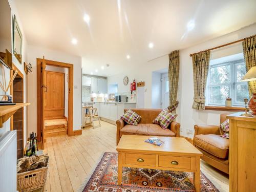 a living room with a couch and a table at The Holly Tree Cottage in Rashfield