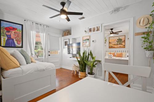 a living room with a couch and a ceiling fan at Entire cottage in Tampa in Tampa