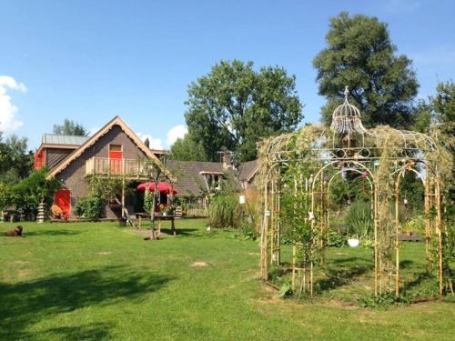 a garden with a gazebo in front of a house at Reijgershof - The Barok lounge in Amsterdam