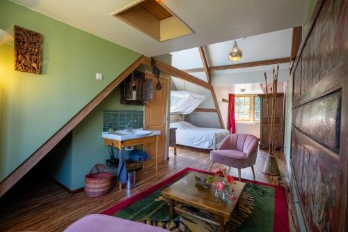 a attic room with a sink and a bedroom at Reijgershof - Bali Suite with private terrace in Amsterdam