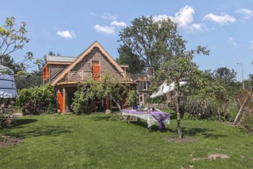 a house with a table in the yard at Reijgershof - Bali Suite with private terrace in Amsterdam