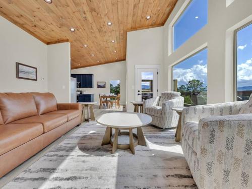 a living room with a couch and a table at The Glass Chalet in Williamsburg