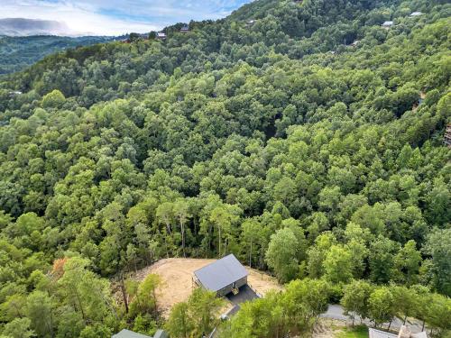 an aerial view of a barn in the middle of a forest at The Glass Chalet in Williamsburg