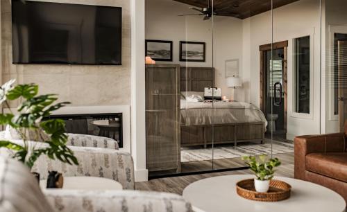 a living room with a bed and a fireplace at The Glass Chalet in Williamsburg